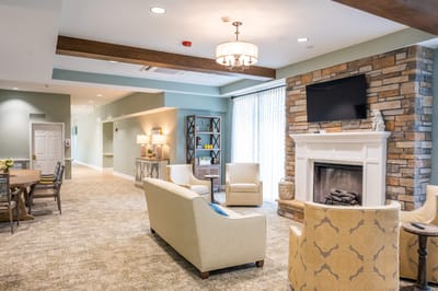 Bright common area with seating and a fireplace