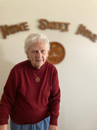 A resident in a senior living facility with a warm smile