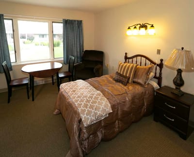 Cozy private resident room with a bed and seating area