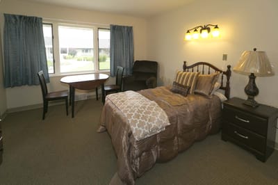 Cozy private room with a bed and sitting area
