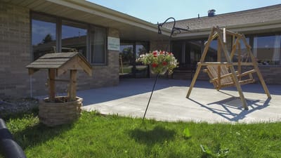 Outdoor area with swing and flower planter
