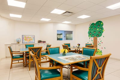 Bright common area with tables and creative wall decor