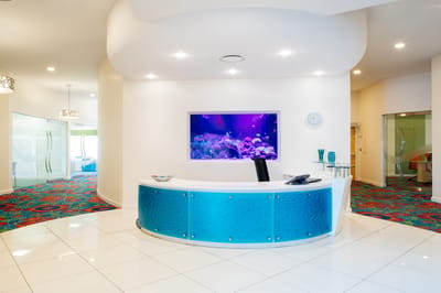 Bright interior view of a reception area with aquarium