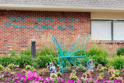 Exterior view of St. Joseph Villa with decorative butterfly statue
