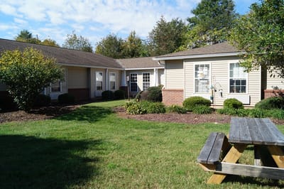 Outdoor space with picnic table and well-kept gardens