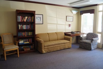 Cozy common area with seating and bookshelves