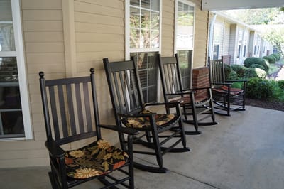 Rocking chairs on a porch outside the facility