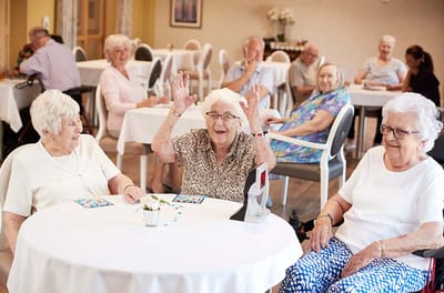 Residents engaged in an activity session, smiling and celebrating