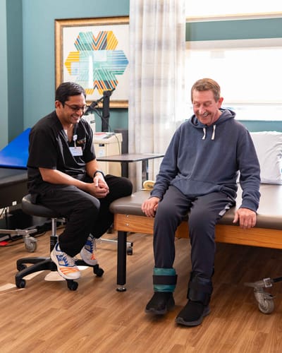 Staff assisting a resident during therapy session