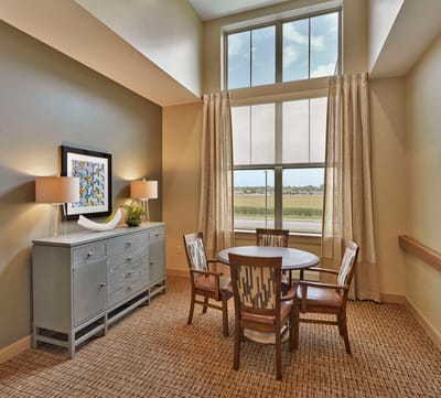 Bright common area with a table and chairs.