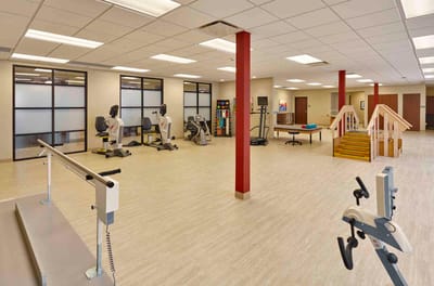Interior view of a rehabilitation gym with equipment.