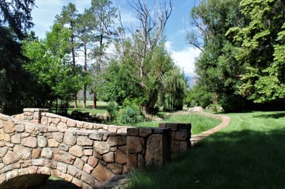 Scenic view of a stone bridge in a green garden