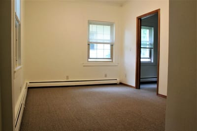 Empty private room with carpet and windows
