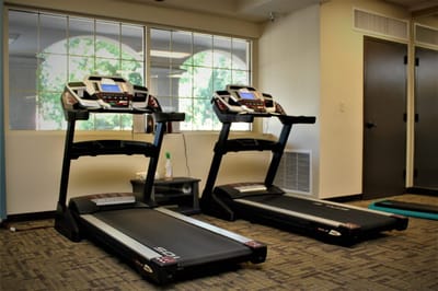 Two treadmills in a well-lit fitness room