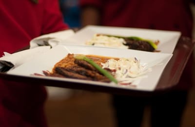 Tray of food being served at a dining event.