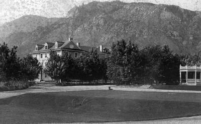 Historical building exterior with surrounding trees.