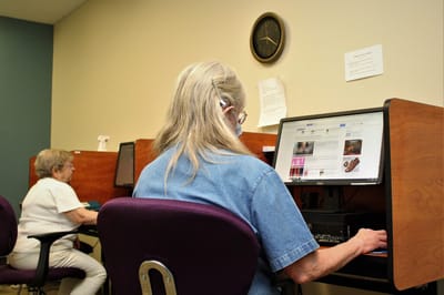 Residents using computers in an activity room