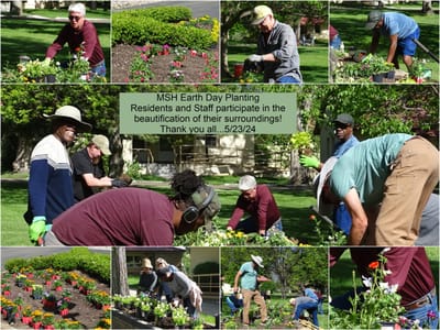Residents and staff planting flowers outdoors.