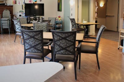 Common area with tables and chairs in the facility