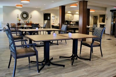 Dining area with tables and chairs in a cozy setting