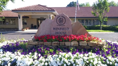Entrance sign with flowers at the facility