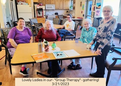 Residents engaged in group therapy gathering.