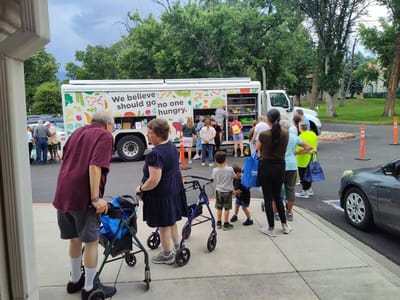 People gathered around a food truck during an event.
