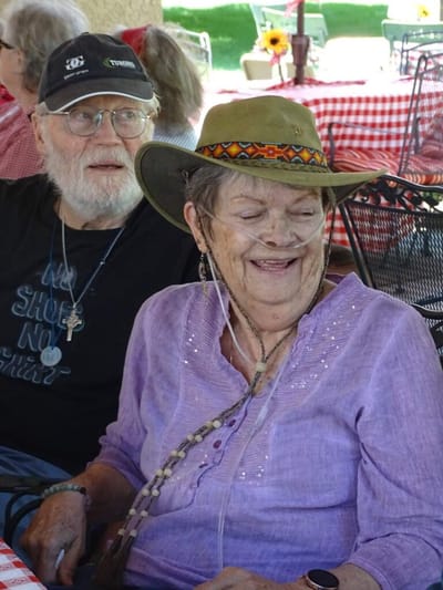 Residents enjoying an outdoor gathering with smiles.