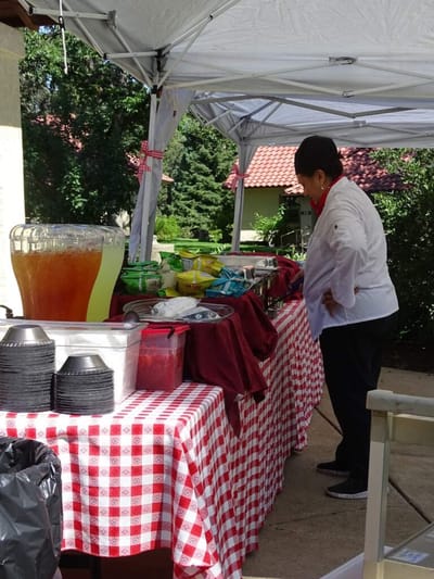 Chef preparing food at an outdoor event.