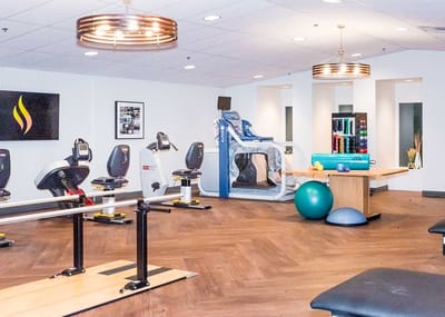 Modern therapy area with exercise equipment and tools.