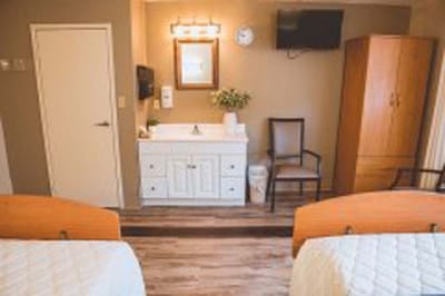 Interior view of a resident room with two beds.
