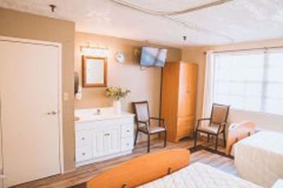 Private resident room with two beds and amenities.