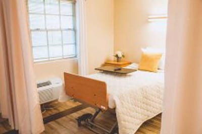 Private resident room with a bed and window.
