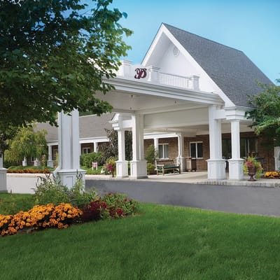 Exterior view of the facility entrance with flowers.