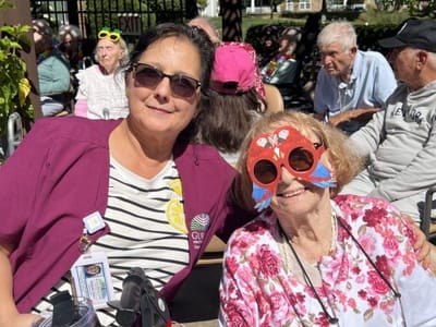 Staff member and resident enjoying an outdoor activity.