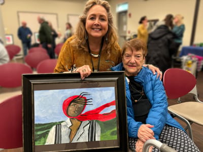 Residents celebrating with artwork in a common area.