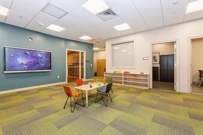 Interior common area with tables and chairs.