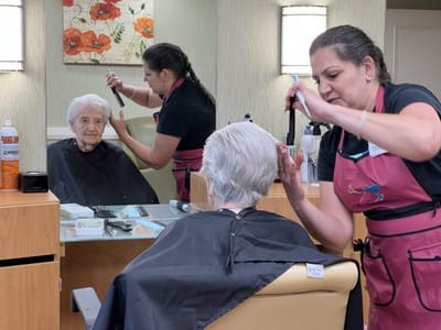 A resident receiving a haircut at the salon.