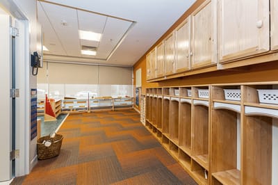 Interior space with wooden lockers and colorful floor
