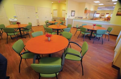 Interior common area with circular tables and chairs.