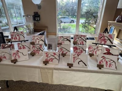Art display table in common area with paintings.