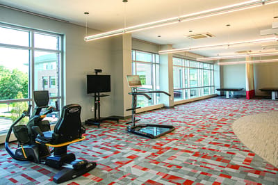 Fitness area with exercise equipment and large windows