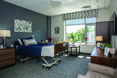 Cozy resident room with a hospital bed and decor.
