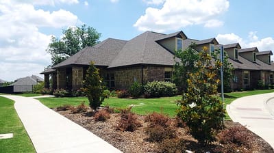 Exterior view of Mayberry Gardens with landscaped pathways.
