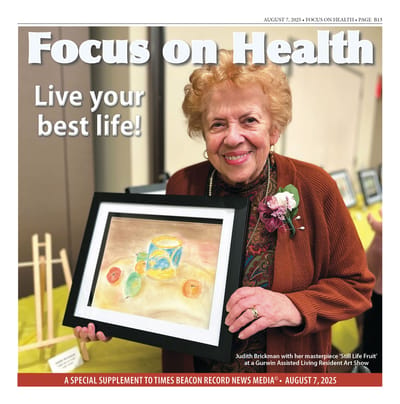 Resident showcasing her artwork at an event.