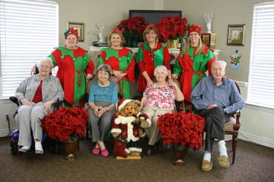 Residents and staff celebrate with festive decor.