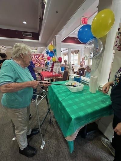 Resident participating in an activity at a table