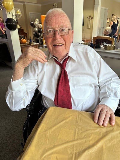 Senior resident enjoying a celebration indoors.