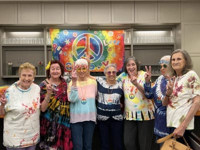 Residents celebrating with peace signs and colorful attire