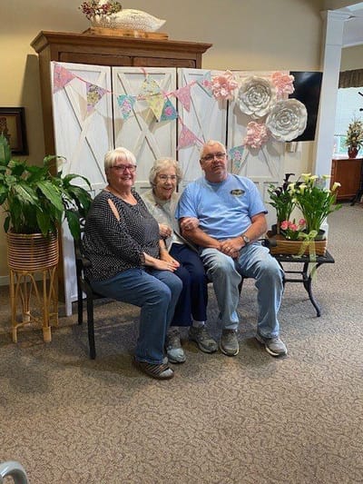 Residents and staff enjoying a cheerful moment indoors.